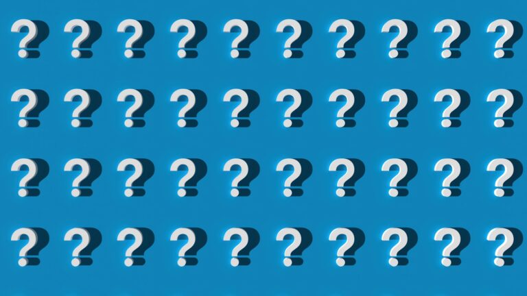 Multiple white question marks on blue background