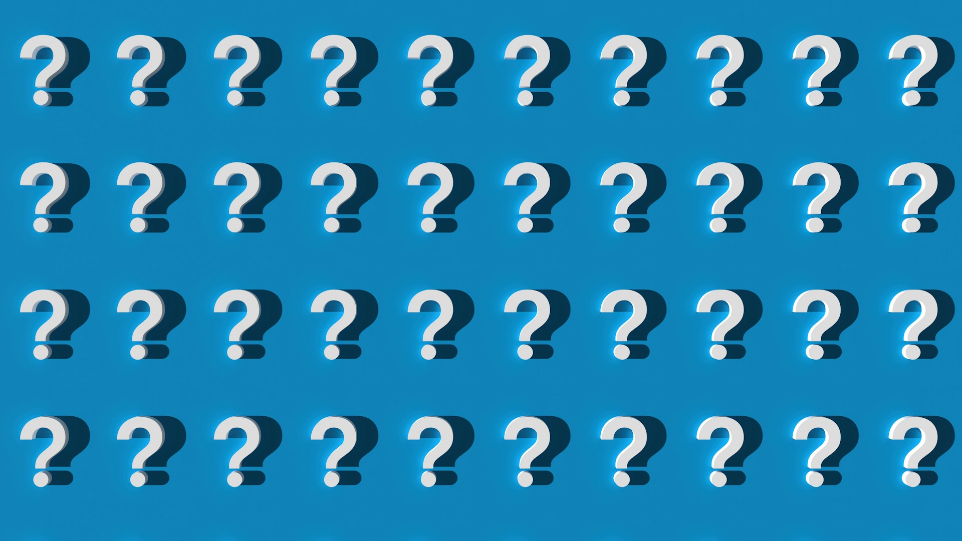Multiple white question marks on blue background