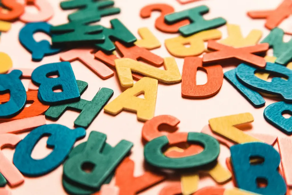 Colorful scattered wooden alphabet letters close-up