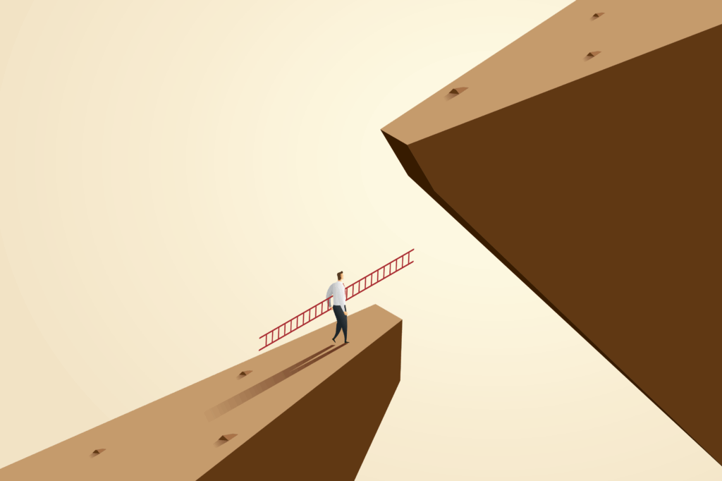 Man contemplating jump between two cliffs