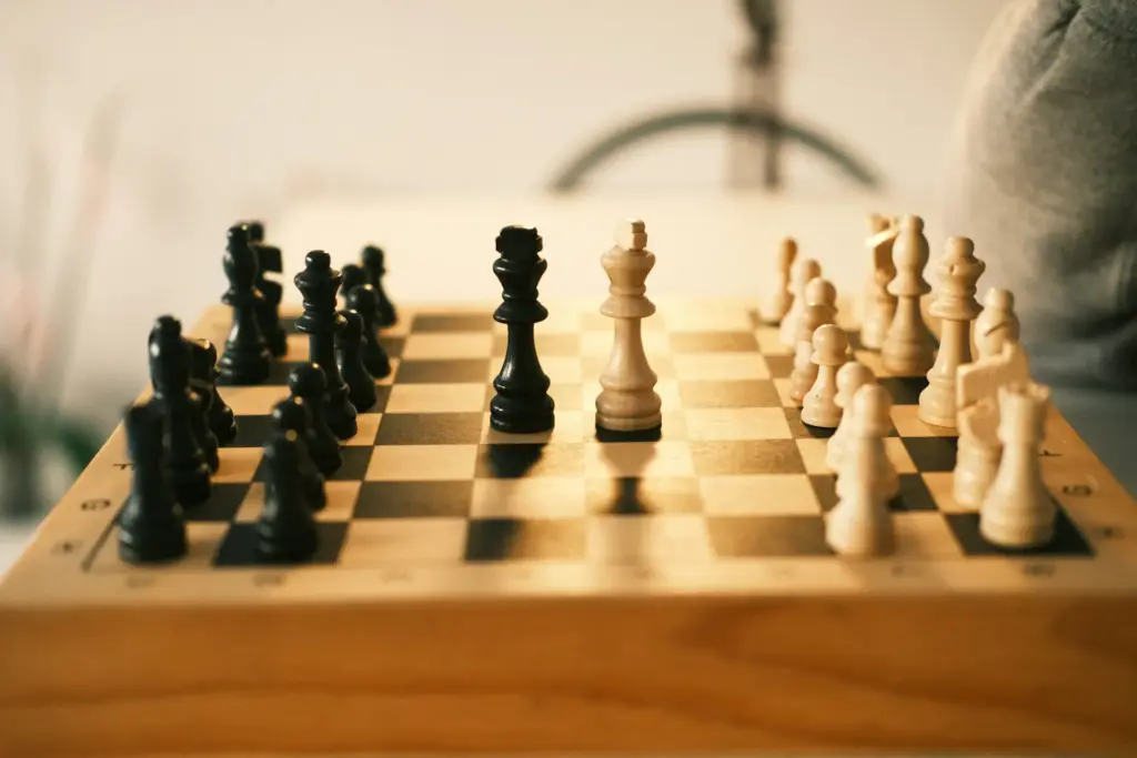 Chess pieces on board during strategic game