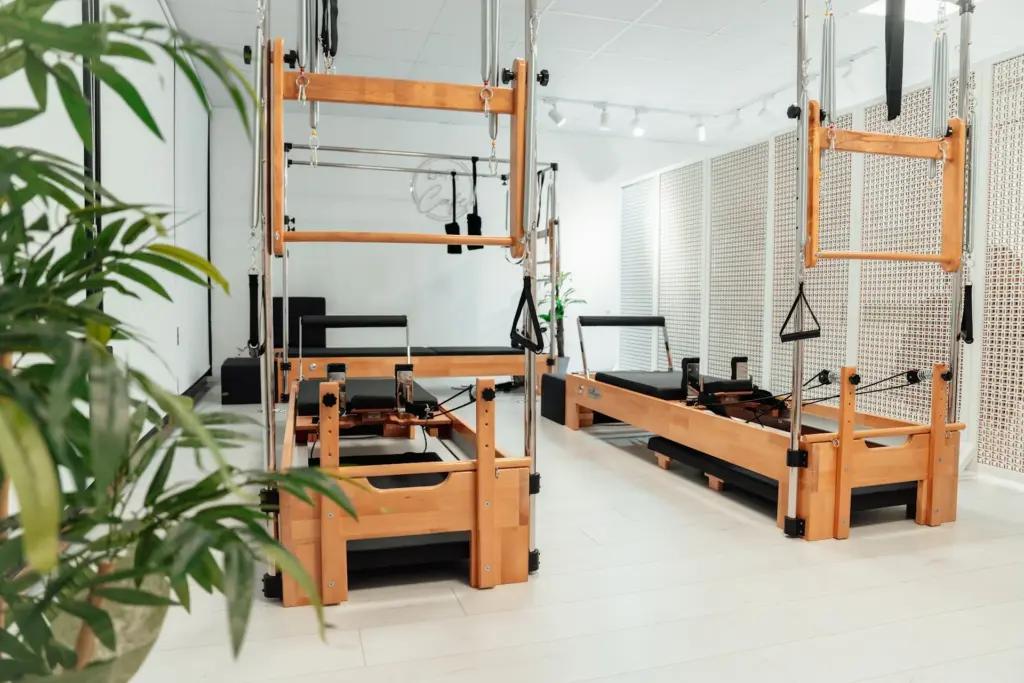 Modern Pilates reformer machines in bright studio